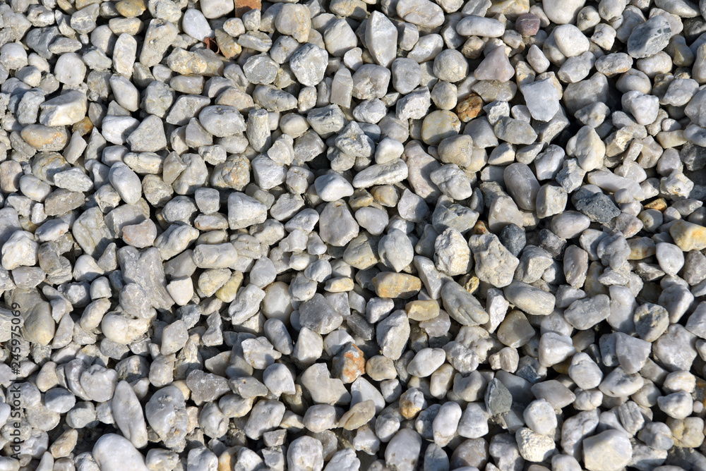 graue Kieselsteine als Hintergrund - Abbau von Steinen im Kieswerk // grey  pebbles as a background - quarrying of stones in the gravel plant Stock  Photo | Adobe Stock