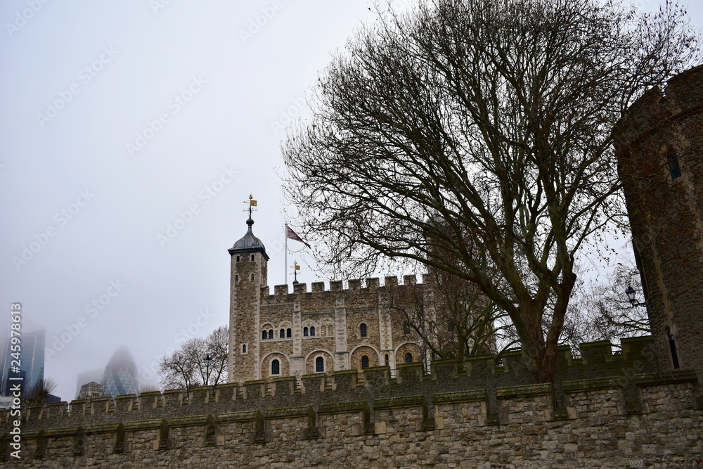The Tower of London. The White Tower with mist and trees. London, United Kingdom.