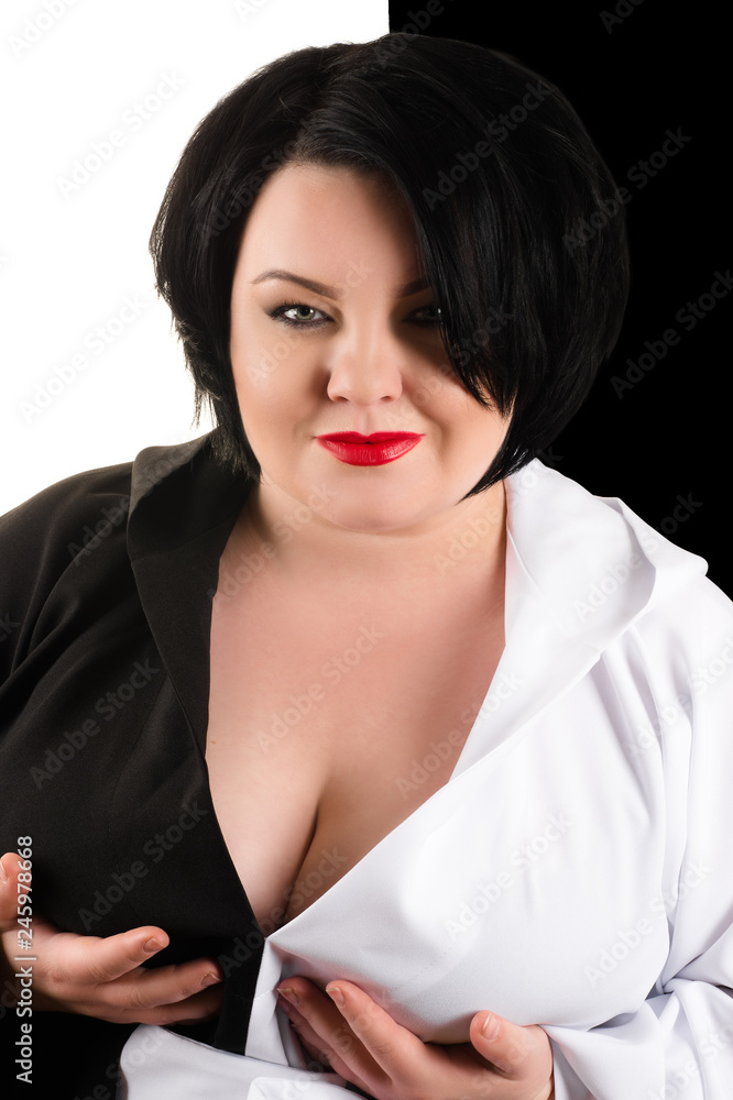fat woman holding big breasts in black and white dress Stock Photo