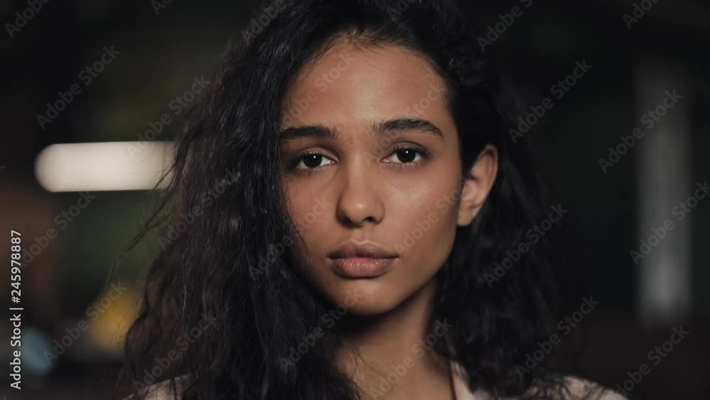 Portrait of attractive young woman looking into the camera in cozy cafe close up Portrait of attractive young woman looking into the camera in cozy cafe close up