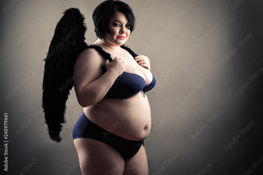 charming fat woman in fashionable lingerie with black wings Stock Photo |  Adobe Stock