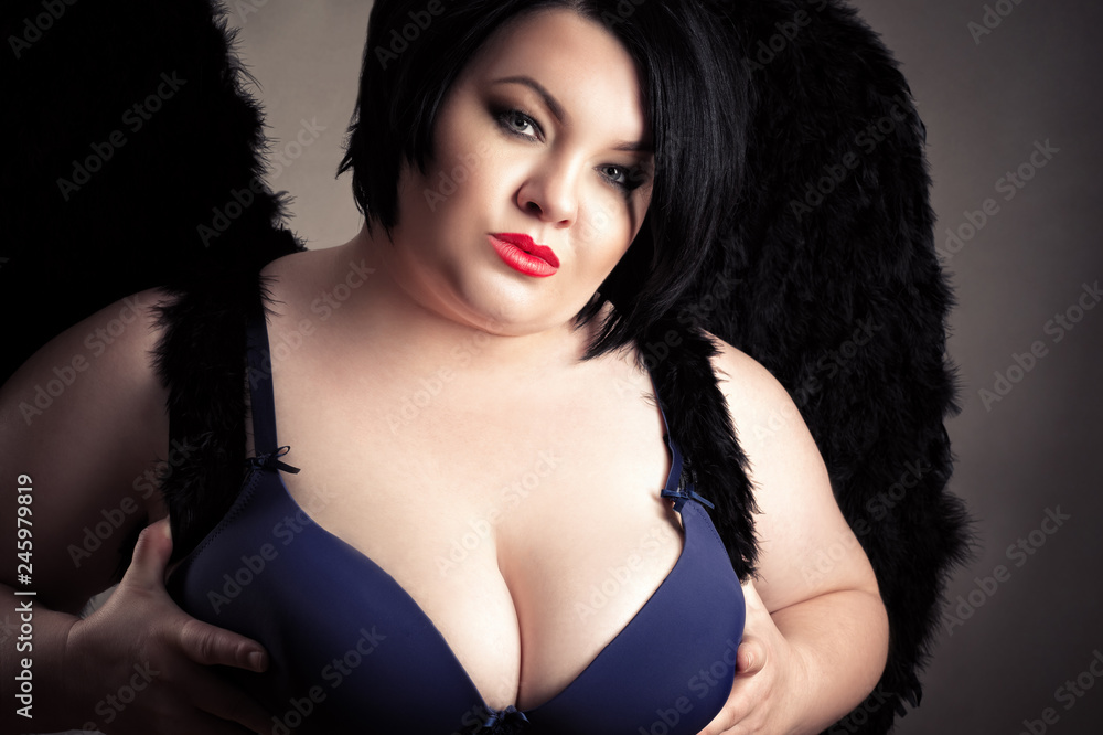 sexy fat woman with big breasts in bra with black wings Stock Photo | Adobe  Stock