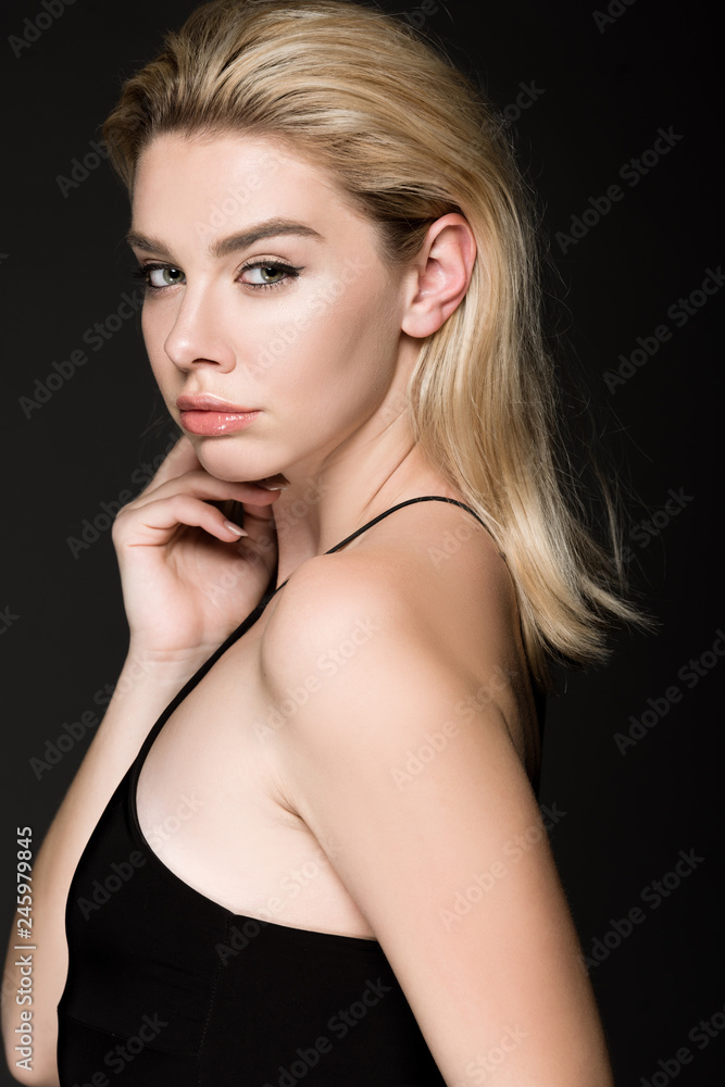 elegant blonde girl in black dress posing isolated on black elegant blonde girl in black dress posing isolated on black
