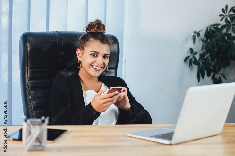 Young girl dressed in business clothes working in the office.