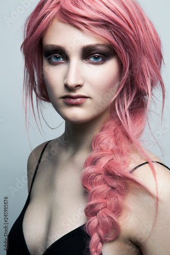 Portrait of young woman with braided pink hair