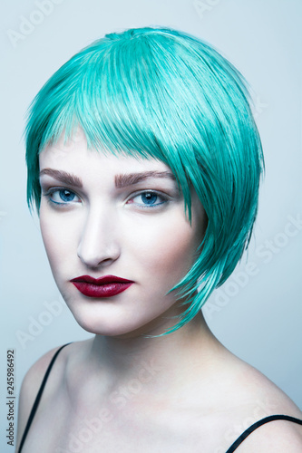 Portrait of young woman with blue hair