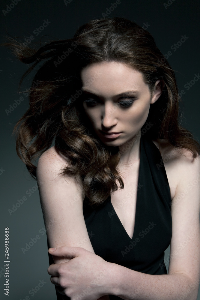 Brunette young woman with arms crossed Brunette young woman with arms crossed