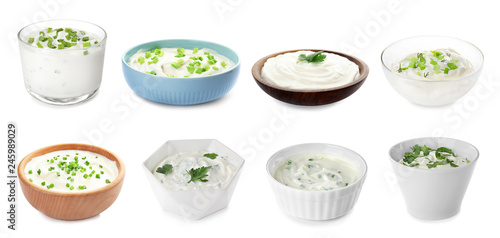 Set of delicious sour cream with herbs in bowls on white background