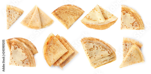 Set of folded tasty thin pancakes on white background, top view