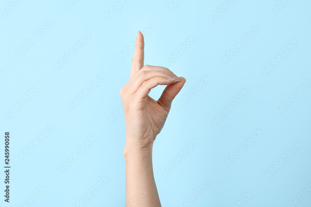 Woman showing D letter on color background, closeup. Sign language Woman showing D letter on color background, closeup. Sign language