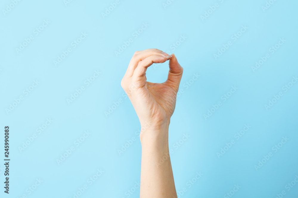 © New Africa - Woman showing O letter on color background, closeup. Sign language © New Africa - Woman showing O letter on color background, closeup. Sign language