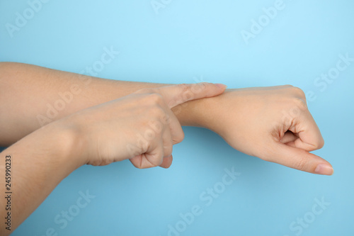 Woman showing word time on color background, closeup. Sign language © New Africa