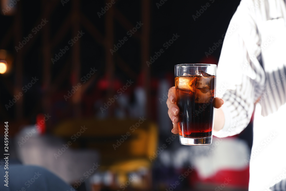 Woman with glass of refreshing cola indoors, closeup. Space for text Woman with glass of refreshing cola indoors, closeup. Space for text