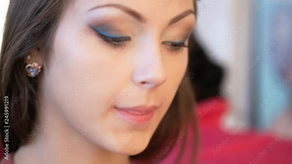 Makeup artist applies mascara. Makeup artist applies mascara.