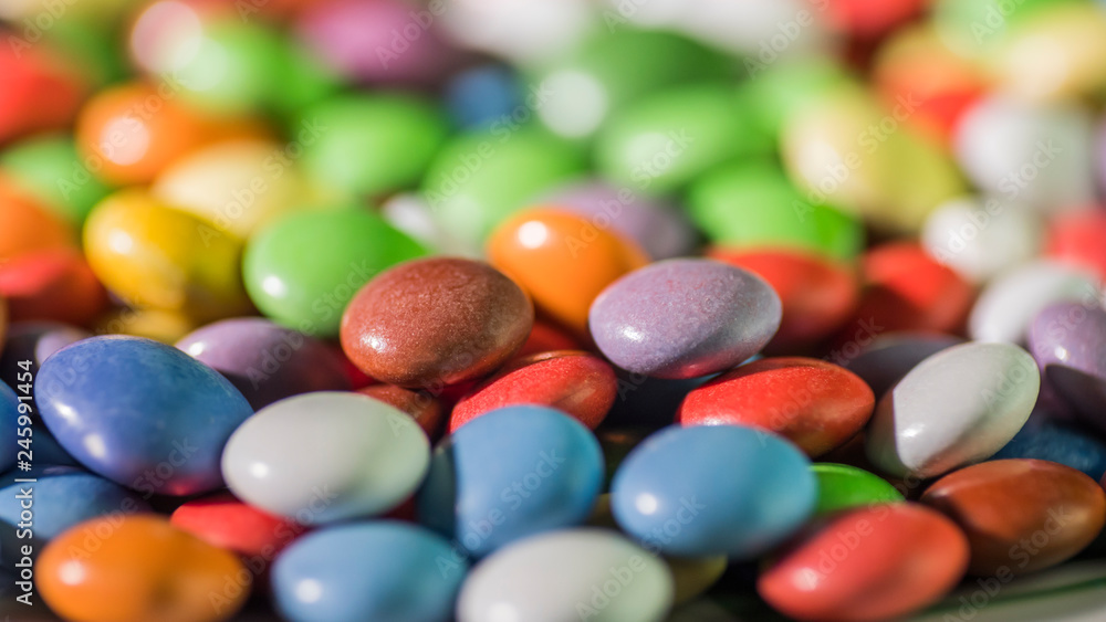 Colorful candy, bright background of round candies in the glaze Colorful candy, bright background of round candies in the glaze