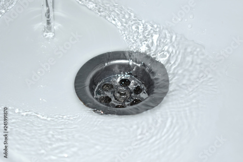 Spływająca woda w umywalce, marnowanie wody © equos