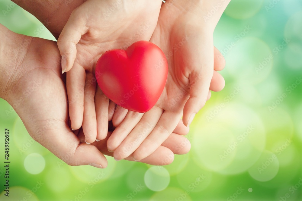 Man and woman holding red heart Man and woman holding red heart