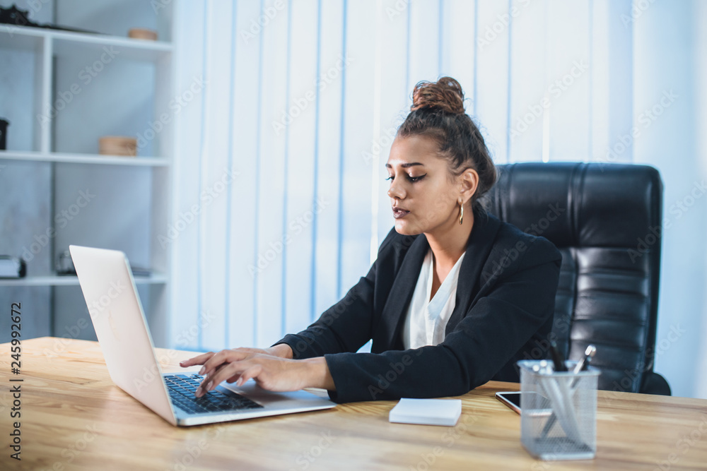 Young businesswoman is a good serious girl working in the office. During this, it checks the documents by reviewing them. Young businesswoman is a good serious girl working in the office. During this, it checks the documents by reviewing them.