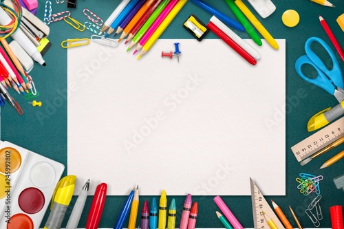 Colorful school supplies on wooden table background