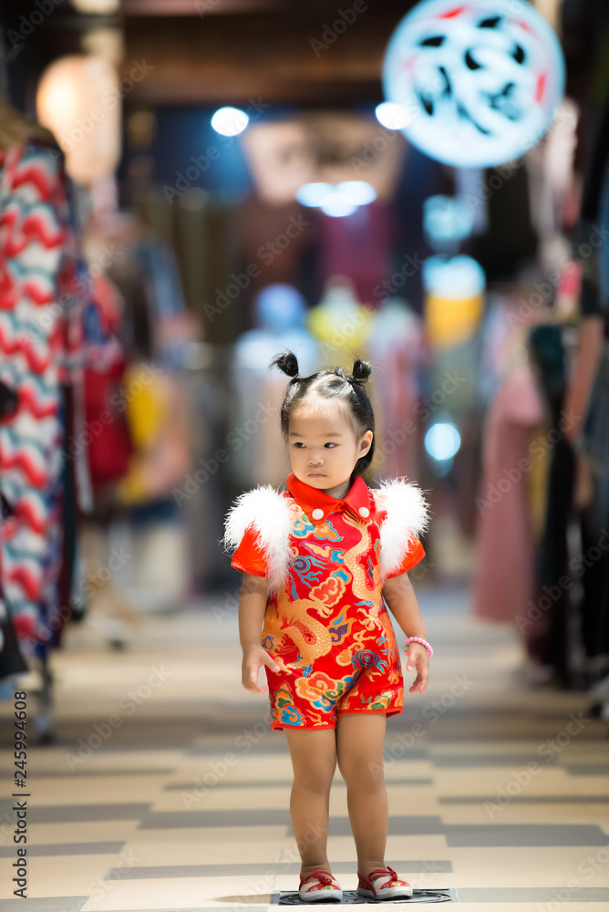 Portrait of cute little girl asian woman in Cheongsam dress,Thailand people,Happy Chinese new year concept