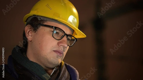 Portrait of architect in yellow helmet with eyeglasess photo