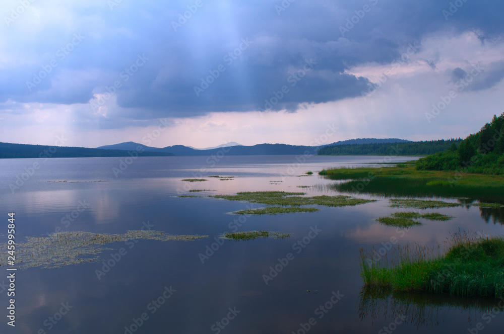 Dark rain clouds over Lake Zyuratkul