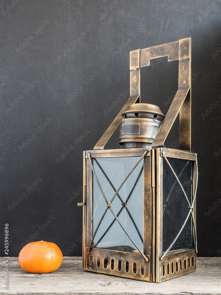 Ancient lantern. Old vintage metal railway lamp on black background. Artistic still life
