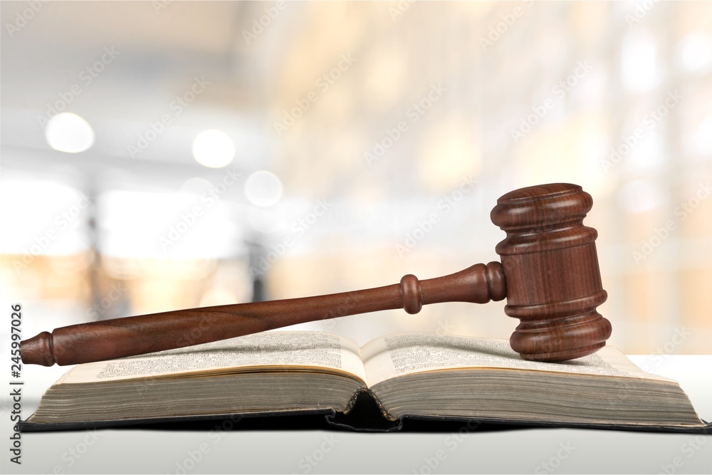 Judge hammer and house on brown wodden table and wall background Judge hammer and house on brown wodden table and wall background