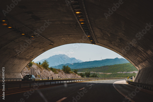 highway tunnel with beautiful view of mountains in the end