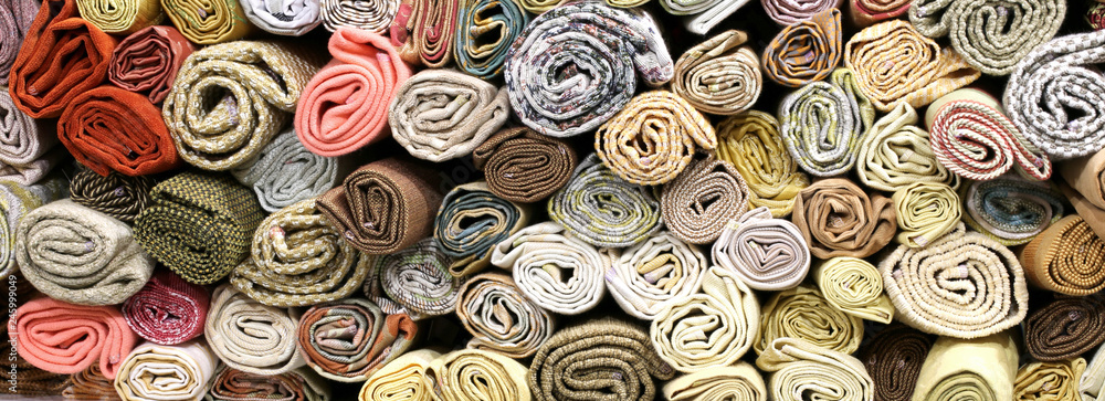 rolls of fabrics on the shelves - obrazy, fototapety, plakaty 