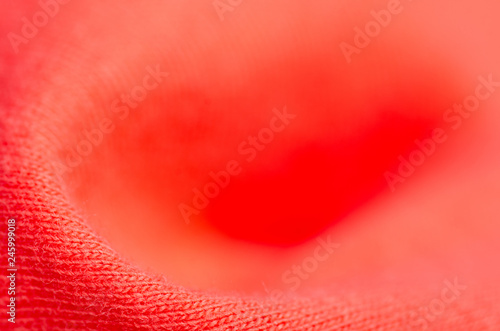 Fabric warm red orange sweater textile material texture blur background macro