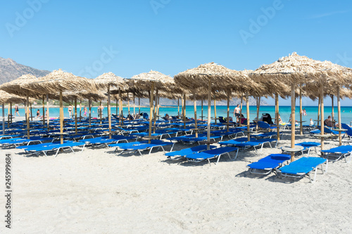 Fototapeta Naklejka Na Ścianę i Meble -  straw sun umbrellas on Elafonisi beach in Crete