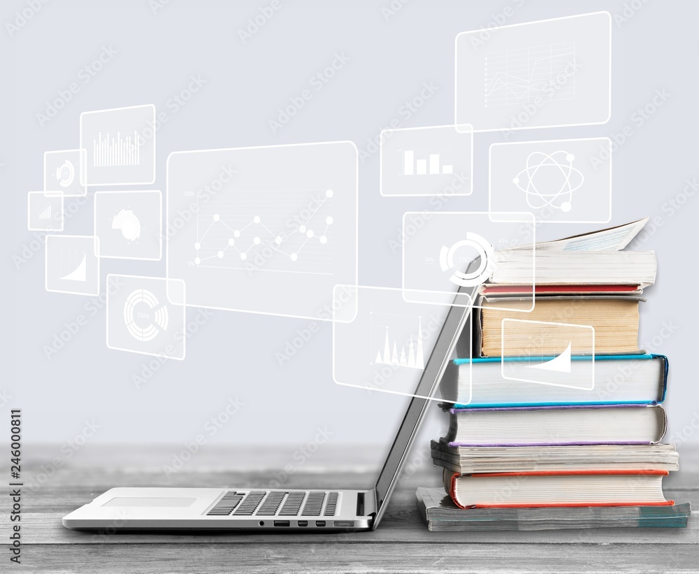 Stack of books with laptop on table Stack of books with laptop on table