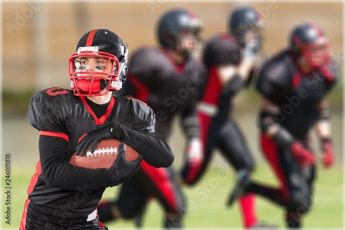 Young american football player in team uniform © BillionPhotos.com