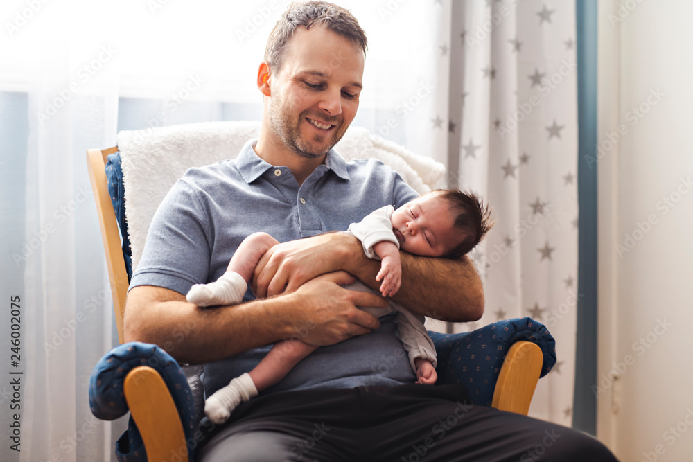 Father and Baby having wonderful time sit on chair one the bedroom Father and Baby having wonderful time sit on chair one the bedroom