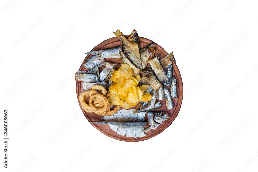 Beer snacks set. Salted, dried fish, squid rings and potato chips,served on the cutting board. Beer snacks set. Salted, dried fish, squid rings and potato chips,served on the cutting board.