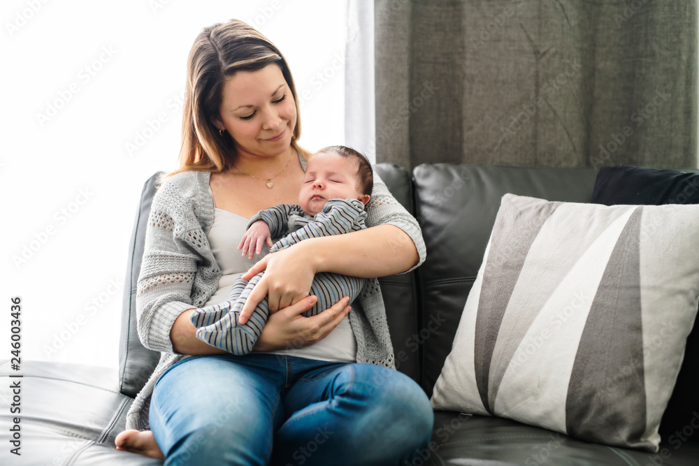 Mother with baby having greet time on the sofa at home Mother with baby having greet time on the sofa at home