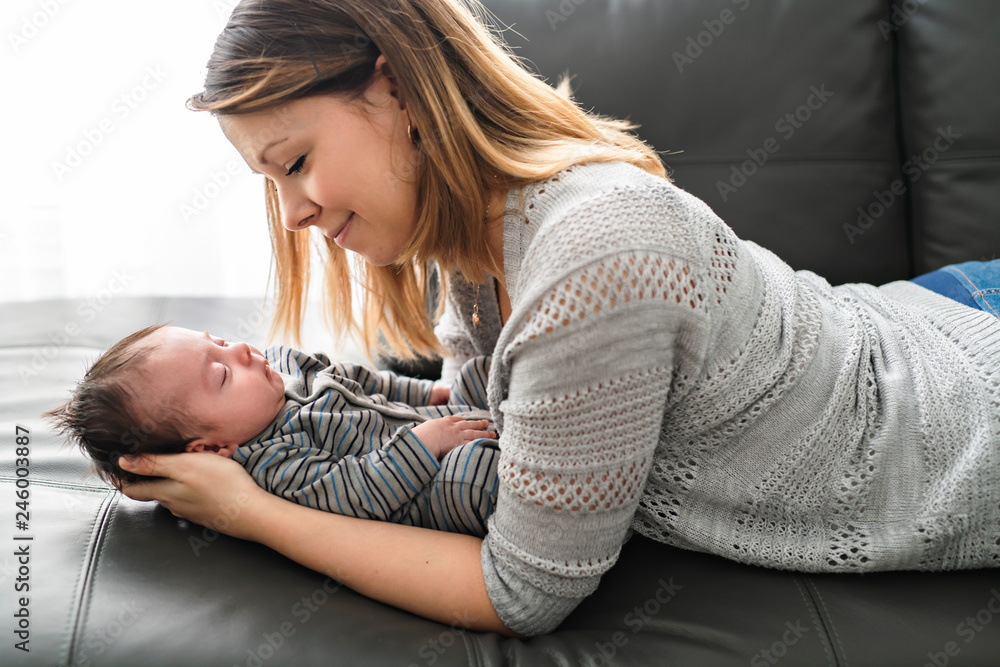 Mother with baby having greet time on the sofa at home Mother with baby having greet time on the sofa at home