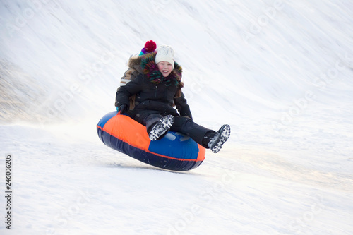 .Child sledding cheesecake.Sledding off a snow slide