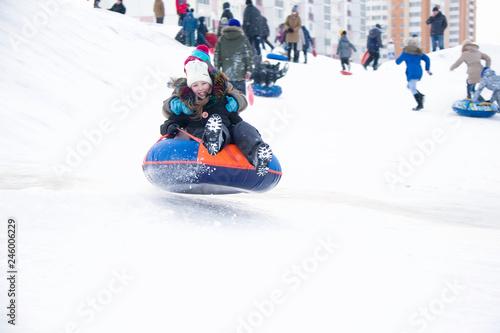 Belarus, the city of Gomel, January 07, 2018.Central Park.Child sledding cheesecake.Sledding off a snow slide.Kids are sleeping on toboggan