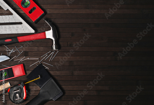 set of wizard for repair and construction of wood on a black wooden background