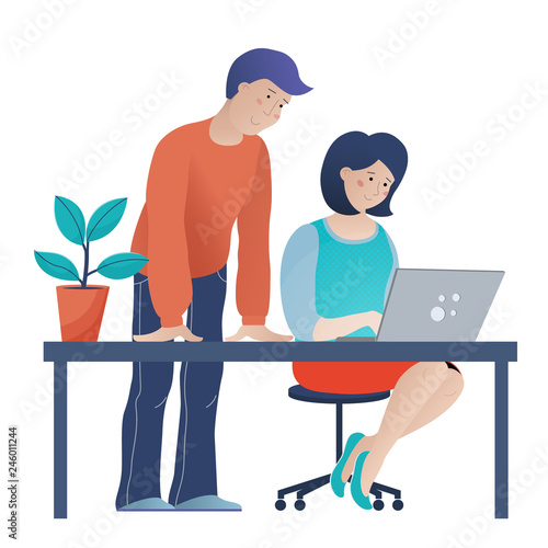 Man helping young woman work on computer in office photo