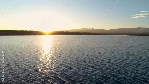 Aerial of Birds Flying on a Colorado Lake at Sunset photo