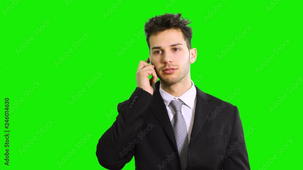 Smiling businessman talking at the phone isolated on green screen chroma key Smiling businessman talking at the phone isolated on green screen chroma key