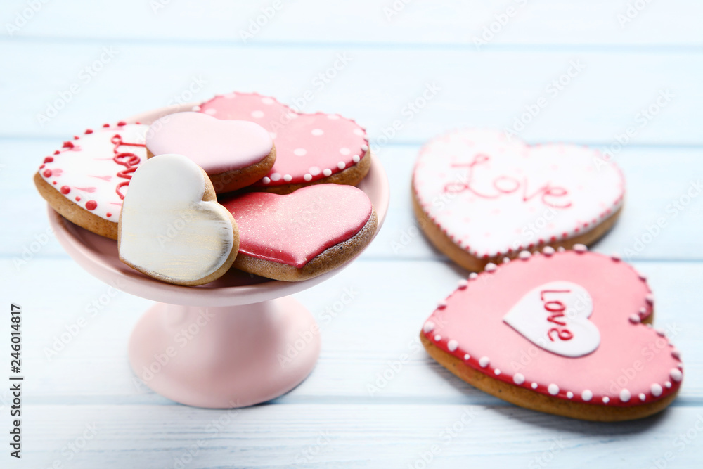 Valentine day heart shaped cookies with cake stand on wooden table Valentine day heart shaped cookies with cake stand on wooden table