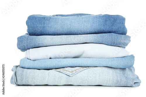 Stack of folded jeans isolated on white background