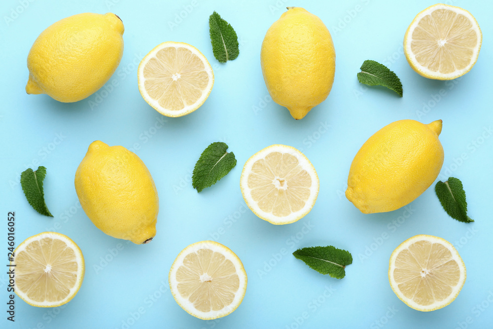 Ripe lemons with green leafs on blue background