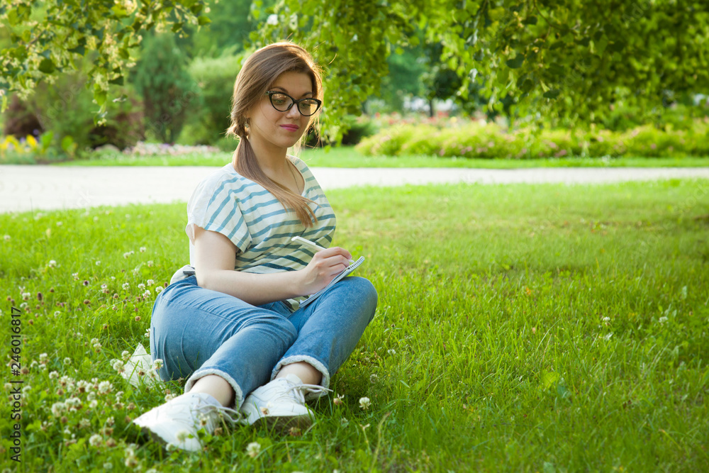 Pretty young student girl making notes in a diary Pretty young student girl making notes in a diary