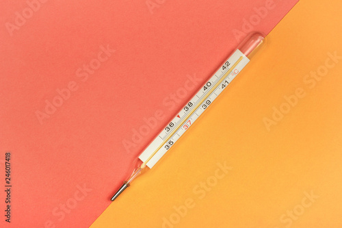Medical mercury thermometer, Living Coral, trendy color 2019 background.  Free space for text.