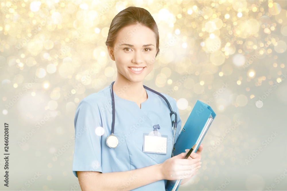 Attractive young female doctor with blurred hospital interior on Attractive young female doctor with blurred hospital interior on